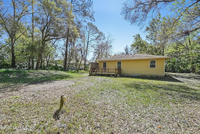 exterior space with a deck, a yard, and crawl space