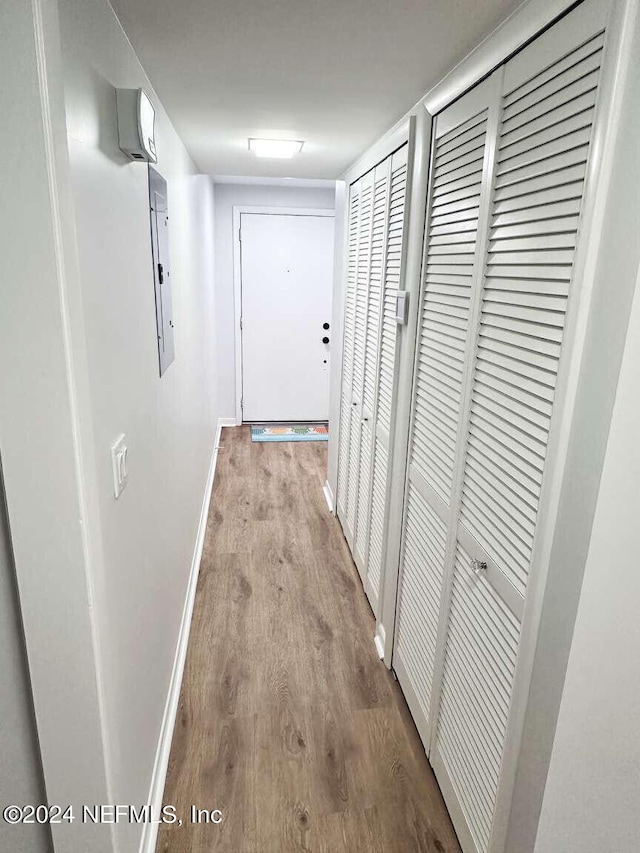 hall featuring electric panel and light wood-type flooring