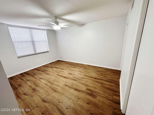 spare room with wood-type flooring and ceiling fan