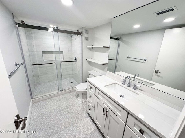 bathroom with walk in shower, vanity, and toilet