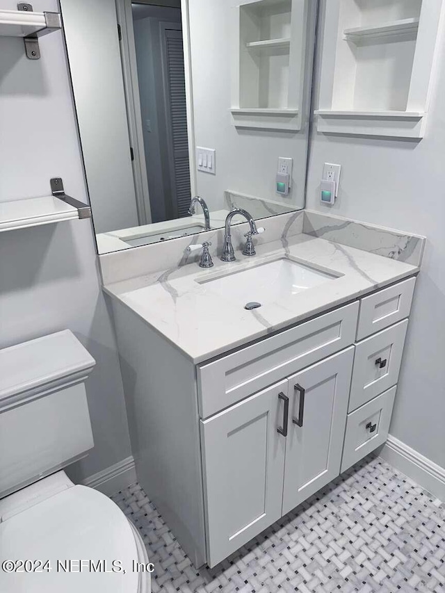 bathroom with vanity and toilet