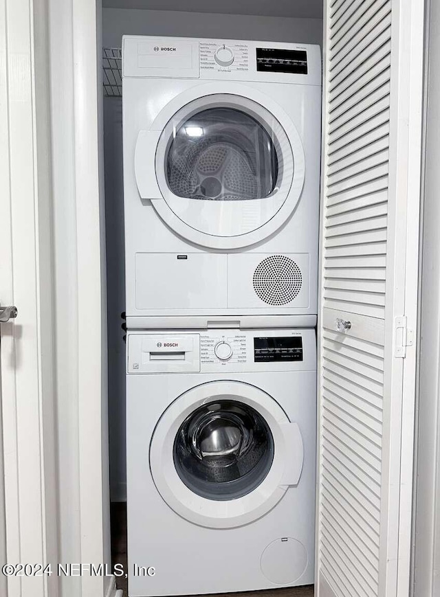 laundry room with stacked washer and dryer