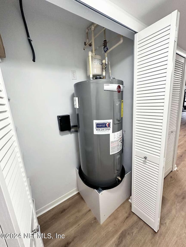 utility room featuring water heater