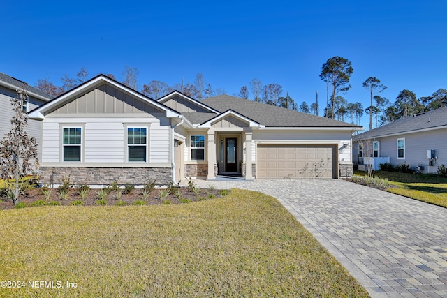 view of front of house featuring a front yard and a garage