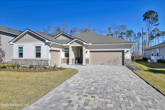 view of front of home with a front yard and a garage