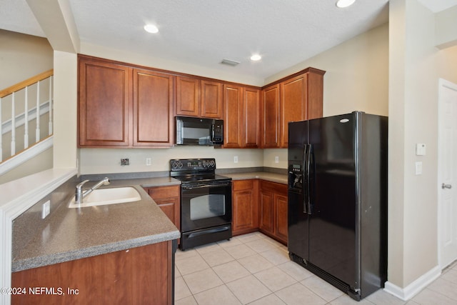 kitchen with black appliances, light tile patterned flooring, and sink