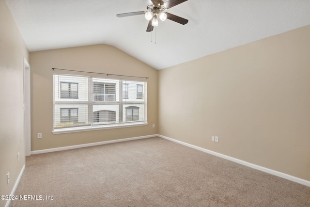 empty room featuring light carpet, ceiling fan, and lofted ceiling