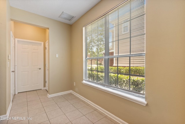 unfurnished room with light tile patterned floors