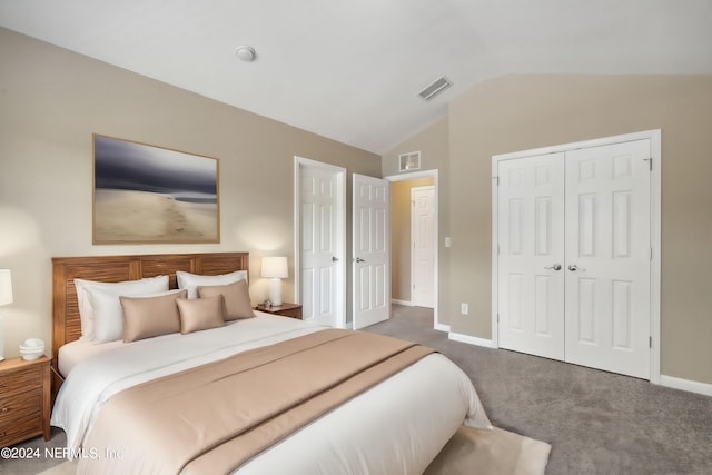 bedroom with dark colored carpet, a closet, and vaulted ceiling