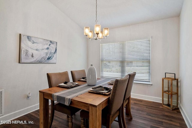 dining room featuring dark hardwood / wood-style floors, an inviting chandelier, and lofted ceiling