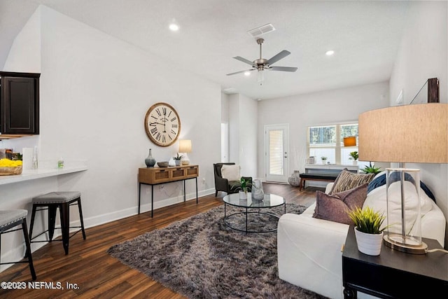 living room with ceiling fan and dark hardwood / wood-style flooring