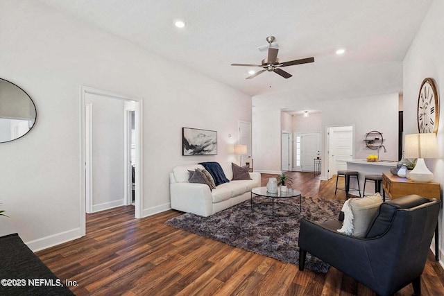 living room with vaulted ceiling, ceiling fan, and dark hardwood / wood-style floors