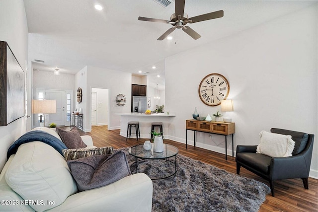 living room with ceiling fan and dark wood-type flooring