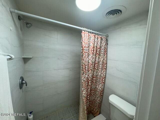 1707 El Prado Rd Unit 2, Jacksonville, FL 32216 - bathroom with a shower stall and toilet
