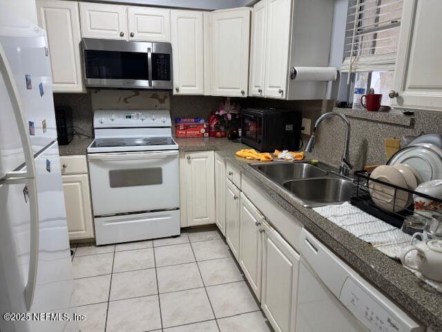 1707 El Prado Rd Unit 2, Jacksonville, FL 32216 - kitchen featuring white appliances, white cabinetry, and light tile patterned floors