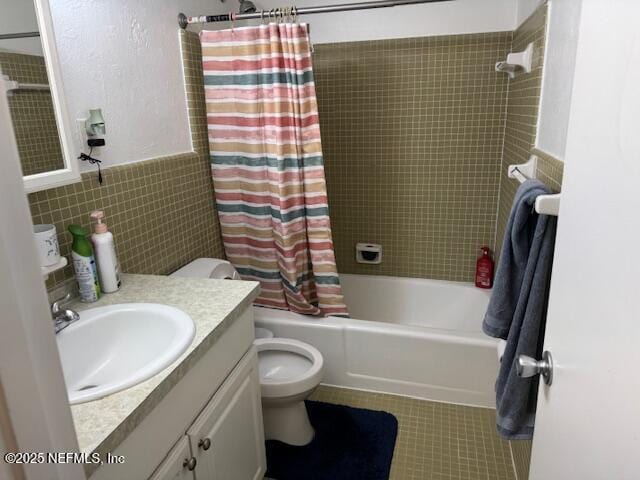 1707 El Prado Rd Unit 2, Jacksonville, FL 32216 - bathroom featuring tile walls, shower / tub combo with curtain, vanity, wainscoting, and tile patterned floors