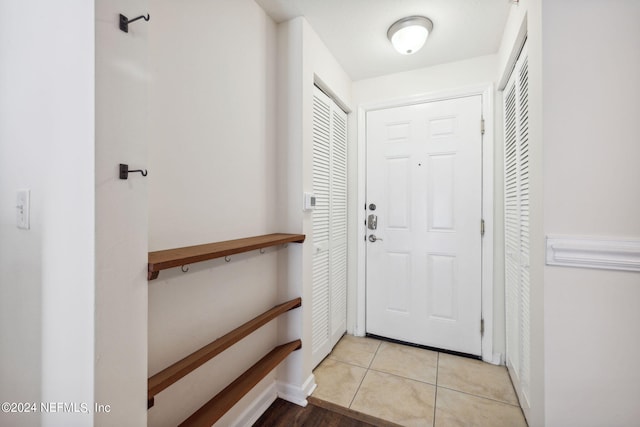 entryway with light tile patterned flooring