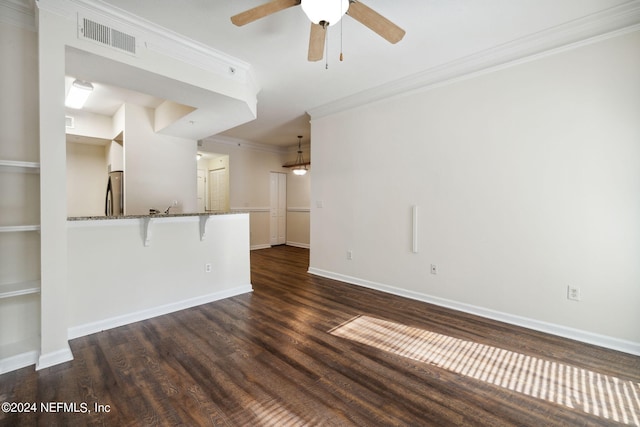 unfurnished living room with crown molding, ceiling fan, and dark hardwood / wood-style floors