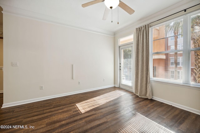 empty room with dark wood-type flooring, ceiling fan, and ornamental molding