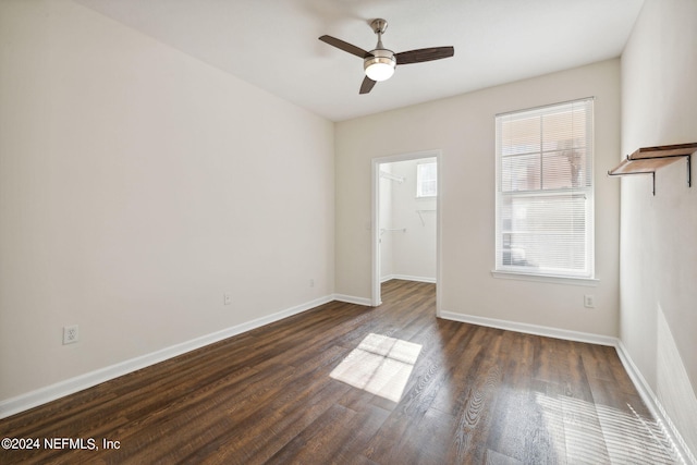 spare room featuring ceiling fan and dark wood-type flooring