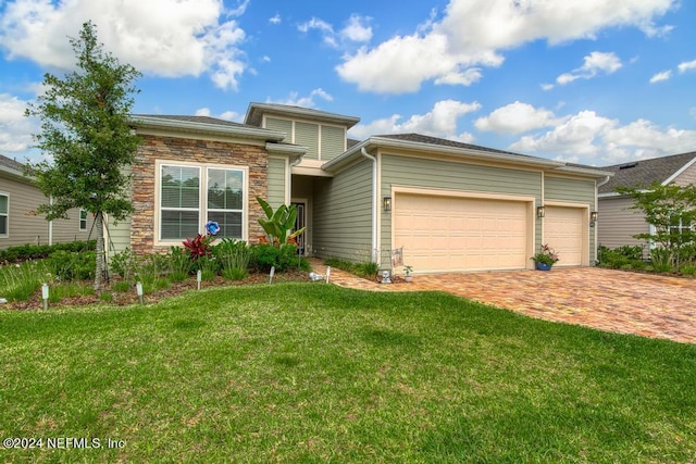 view of front of property with a garage and a front yard