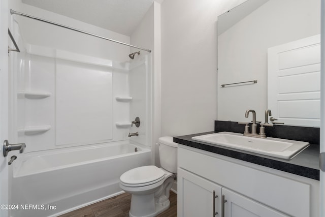 full bathroom featuring hardwood / wood-style flooring, vanity, toilet, and shower / bathing tub combination