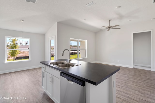 kitchen with sink, stainless steel dishwasher, decorative light fixtures, a kitchen island with sink, and white cabinets