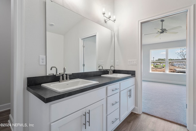 bathroom featuring hardwood / wood-style floors, vanity, ceiling fan, and lofted ceiling