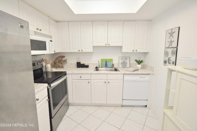 kitchen featuring white cabinets, light tile patterned floors, sink, and appliances with stainless steel finishes