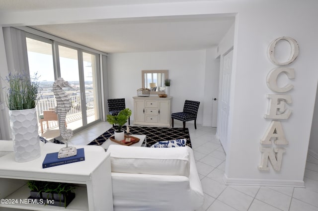 tiled living room featuring expansive windows