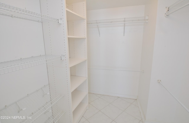 walk in closet featuring tile patterned flooring