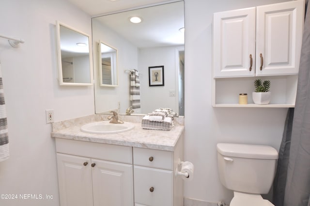 bathroom featuring vanity and toilet