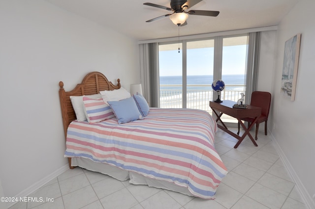 bedroom featuring floor to ceiling windows, a water view, ceiling fan, access to exterior, and light tile patterned floors