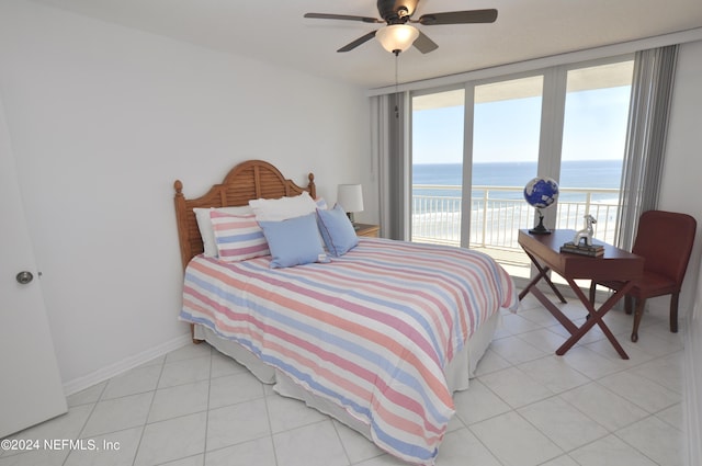 tiled bedroom with ceiling fan, a water view, access to outside, and multiple windows