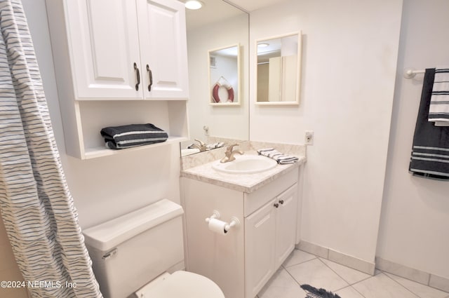 bathroom featuring tile patterned floors, vanity, and toilet