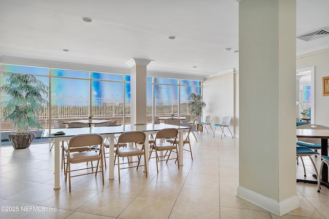 dining room with light tile patterned floors and ornamental molding