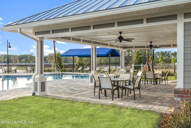 view of patio / terrace with a fenced in pool and ceiling fan