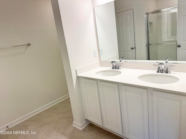 bathroom with tile patterned flooring, an enclosed shower, and vanity