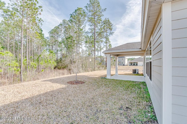 view of yard with a patio area and central AC unit