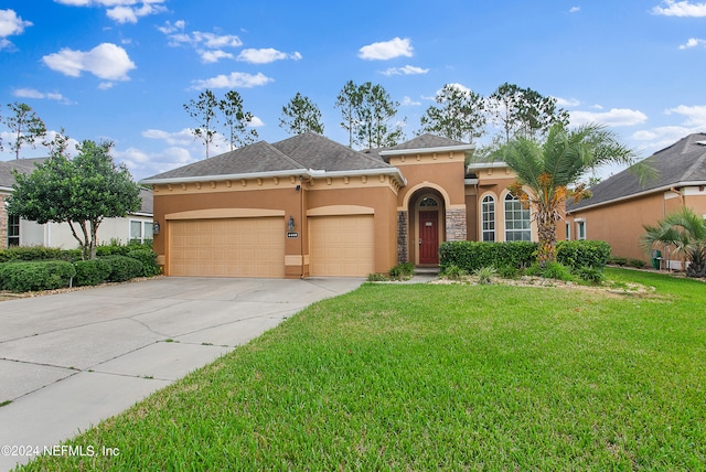 view of front of home featuring a front yard and a garage