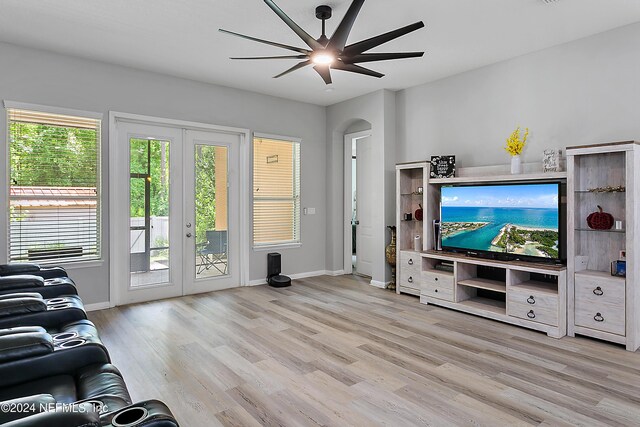 living room featuring ceiling fan, french doors, and light hardwood / wood-style flooring