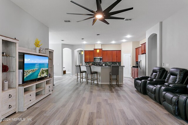 living room with ceiling fan and light wood-type flooring