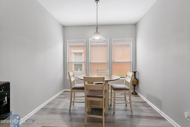 dining space with wood-type flooring