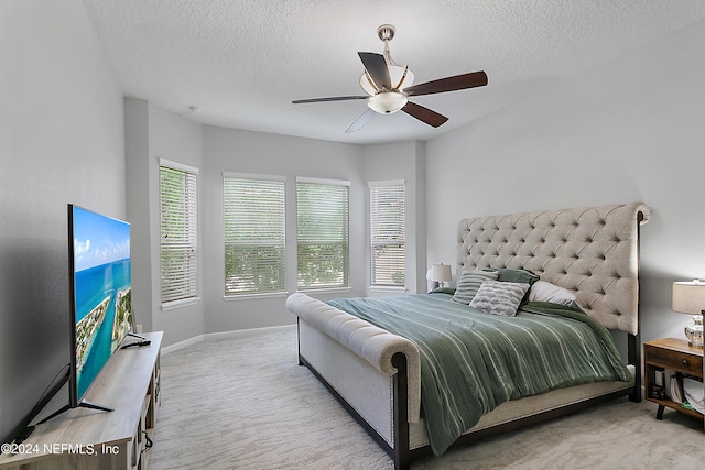 bedroom featuring ceiling fan and a textured ceiling