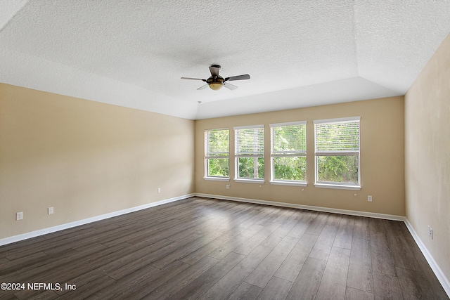 unfurnished room featuring ceiling fan, dark hardwood / wood-style flooring, and a textured ceiling