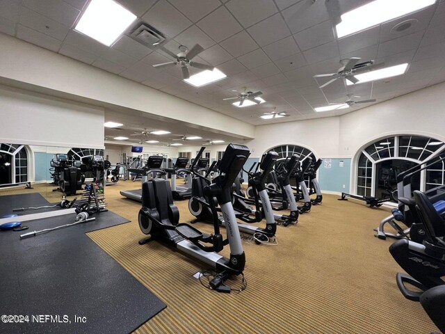 gym featuring ceiling fan and a drop ceiling