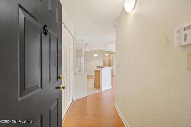 hallway with light hardwood / wood-style flooring