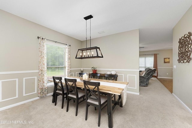 carpeted dining area featuring plenty of natural light