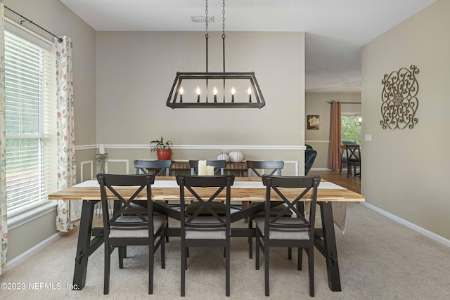 carpeted dining space with a wealth of natural light