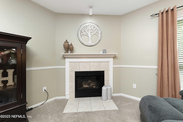 living room featuring a tiled fireplace and light carpet